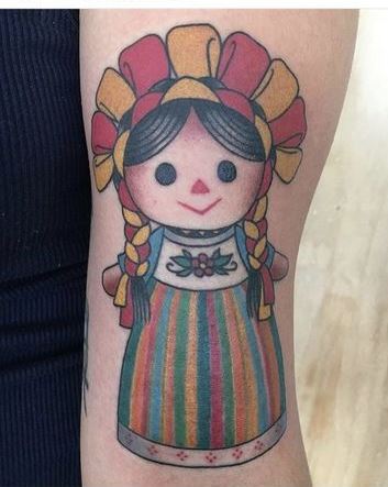 Mexican doll tattoos en el brazo
